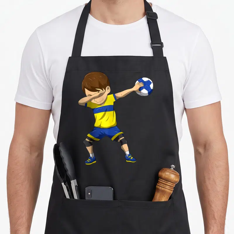 Tablier de cuisine noir avec illustration d'un joueur de handball en train de faire le dabbing avec un ballon.