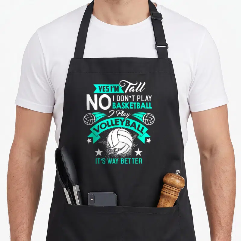 Tablier de cuisine noir avec inscription Yes I'm Tall No I Don't Play Basketball I Play Volleyball It's Way Better et illustrations de ballons.