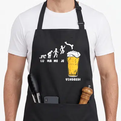 Tablier de cuisine noir avec illustration évolutive LU MA ME JE sautant dans une grande bière au Vendredi.
