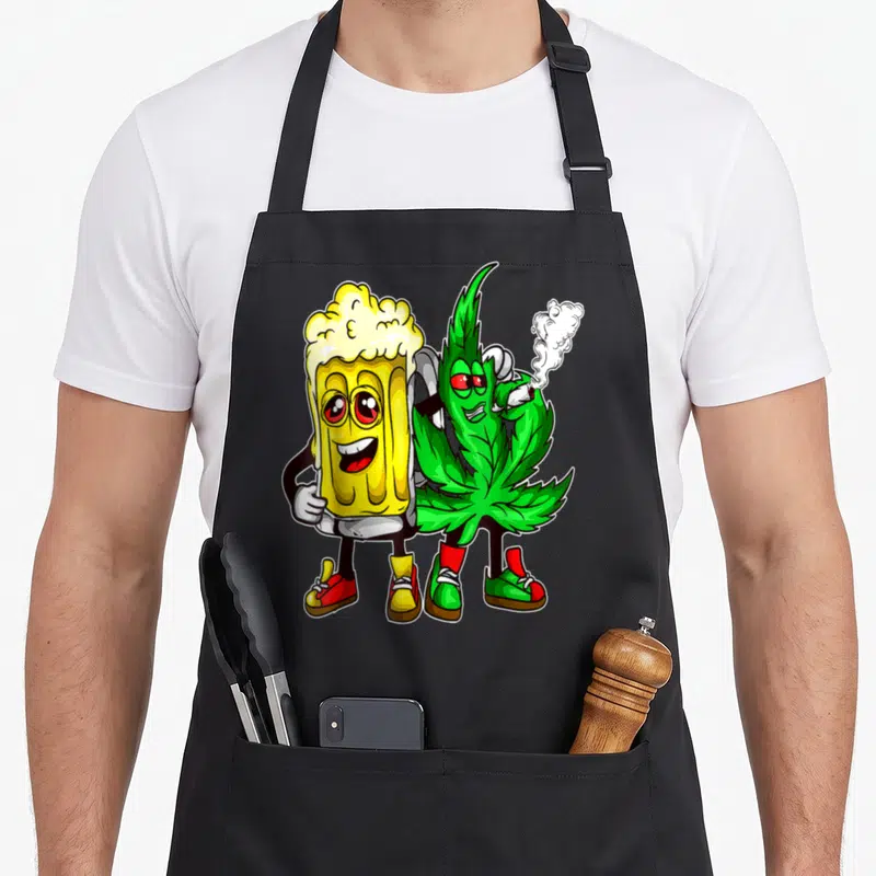 Tablier de cuisine noir avec un verre de bière souriant et une feuille de cannabis fumant en dessin coloré.