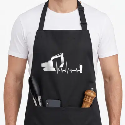 Tablier de cuisine noir avec silhouette de pelleteuse et ligne de battement de cœur se terminant par une bière.