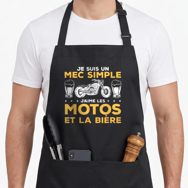 Tablier de cuisine noir avec inscription jaune et illustration blanche moto et verres de bière.