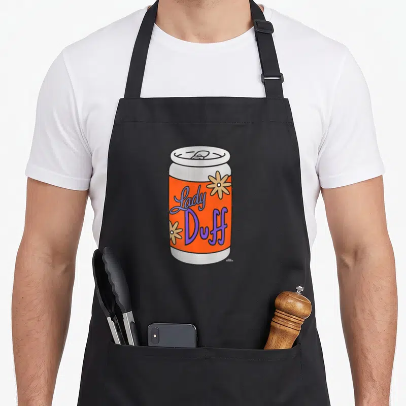 Tablier de cuisine noir avec une illustration colorée d'une canette de bière Lady Duff aux fleurs jaunes.
