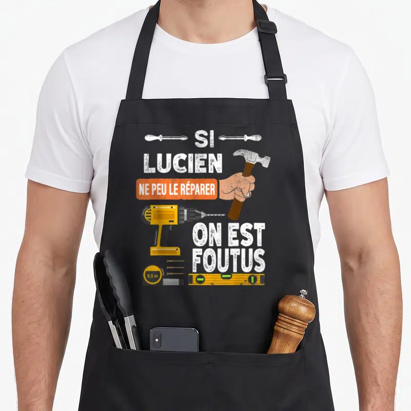 Tablier de cuisine noir avec illustration d'une perceuse, d'un marteau et du texte Si Lucien ne peut le réparer on est foutus.