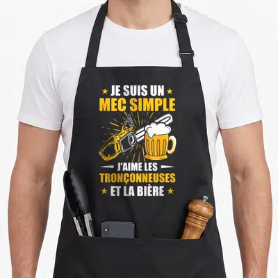 Tablier de cuisine noir avec illustration de tronçonneuse et verre de bière sous le texte Je suis un mec simple.