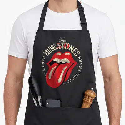 Tablier de cuisine noir avec l'icône des lèvres rouges et le texte Fifty Years des Rolling Stones.