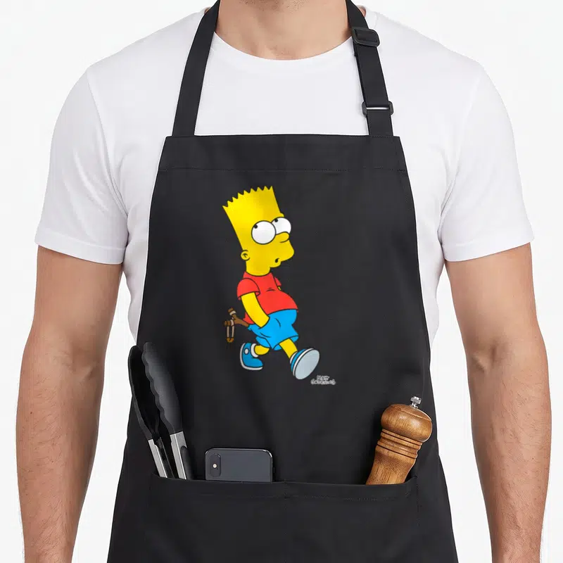 Tablier de cuisine noir avec Barbe Simpson en marche tenant un slingshot derrière son dos.