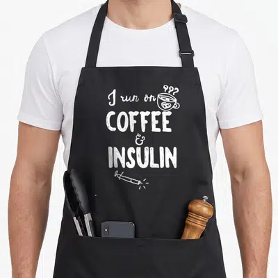 Tablier de cuisine noir avec inscription blanche I run on coffee & insulin et dessin de tasse de café.