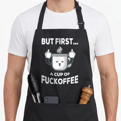 Tablier de cuisine noir avec une tasse blanche aux doigts d'honneur et texte en blanc.