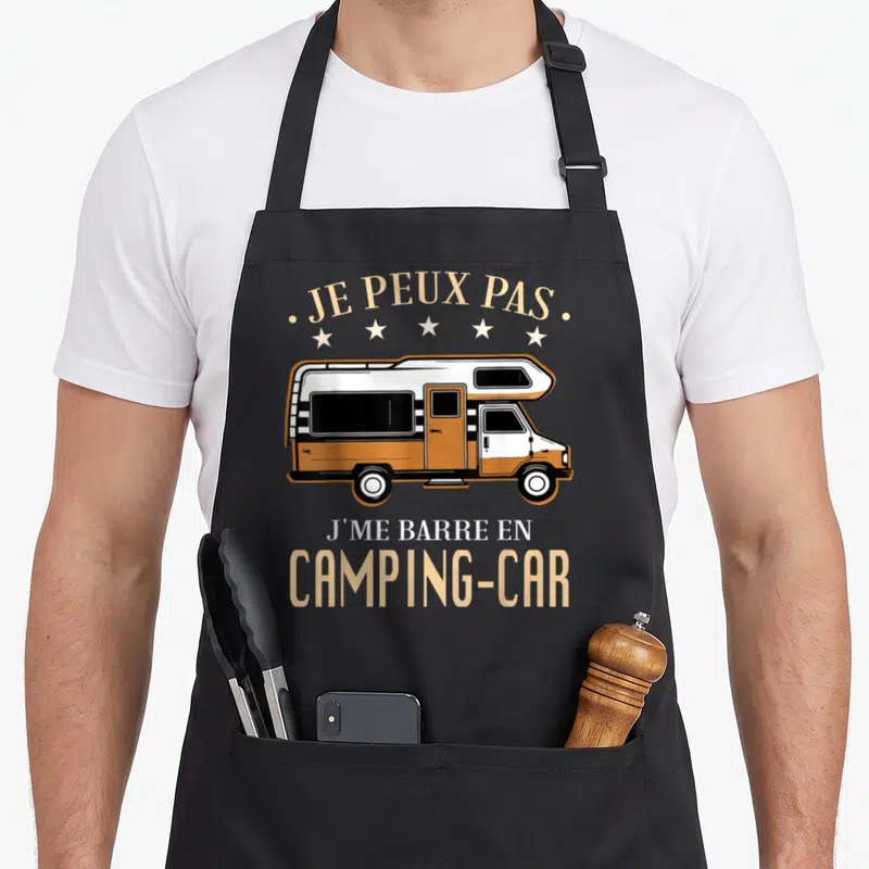 Tablier de cuisine noir avec illustration d'un camping-car orange et blanc et le texte Je peux pas j me barre en camping car.