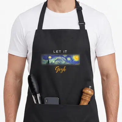 Tablier de cuisine noir avec une reproduction de la Nuit étoilée et le texte Let It Gogh imprimé au centre.
