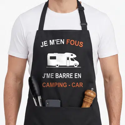 Tablier de cuisine noir avec silhouette camping-car blanche et texte Je m'en fous j me barre en camping car orange et blanc