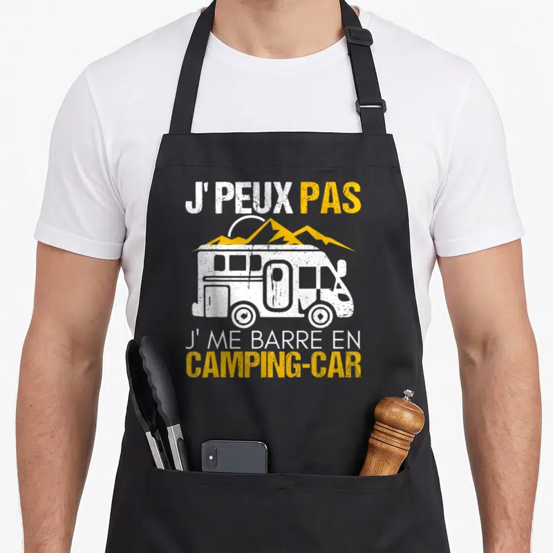 Tablier de cuisine noir avec une illustration de camping-car et le texte J'peux pas j'me barre en camping-car