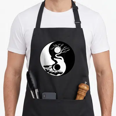 Tablier de cuisine noir avec un motif circulaire fusionnant un arbre bonsaï et le symbole Yin Yang en noir et blanc.