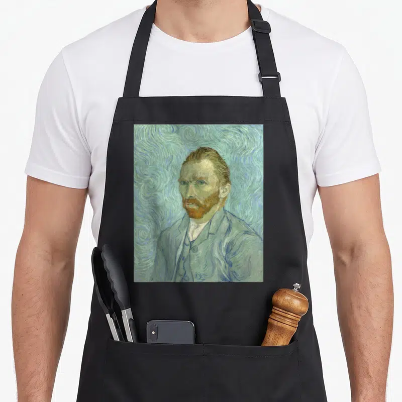 Tablier de cuisine noir avec reproduction de l'Autoportrait de Van Gogh en tons verts et bleus.