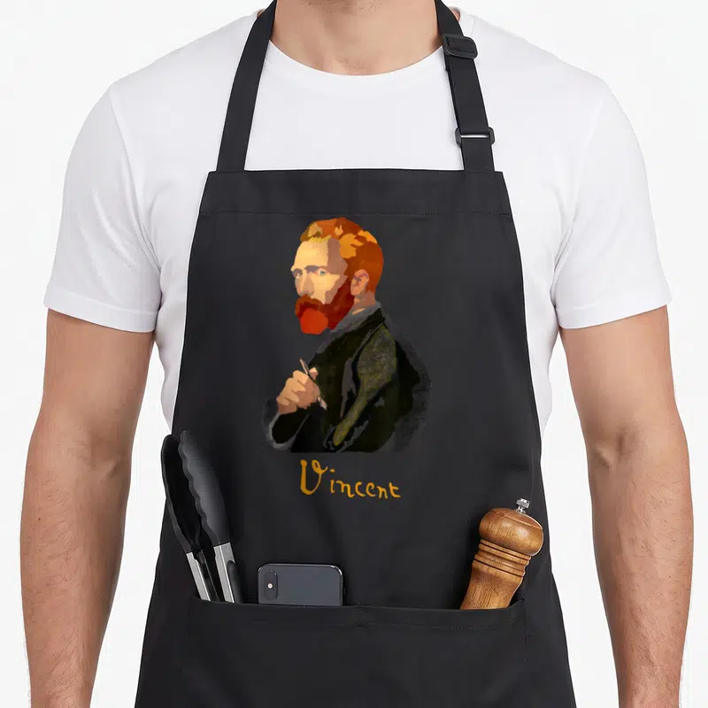 Tablier de cuisine noir avec portrait stylisé de Vincent Van Gogh tenant un pinceau et son nom en dessous.