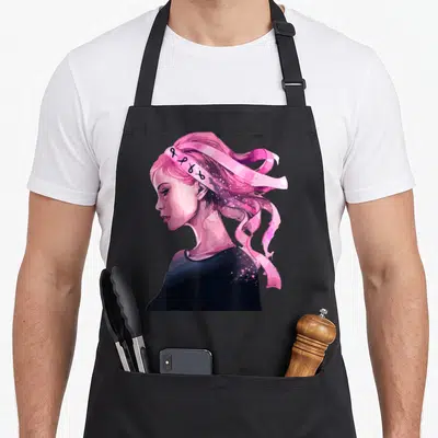 Tablier de cuisine noir avec illustration d'une femme aux cheveux roses et rubans symboliques.