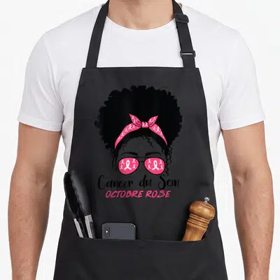 Tablier de cuisine noir avec illustration d'une femme aux lunettes roses et bandana à motifs de rubans Cancer du Sein.