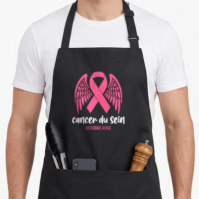 Tablier de cuisine noir avec un ruban rose orné d'ailes et le texte Cancer du Sein Octobre Rose