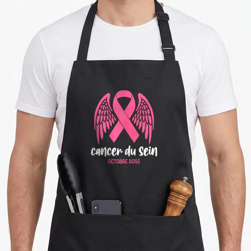 Tablier de cuisine noir avec un ruban rose orné d'ailes et le texte Cancer du Sein Octobre Rose