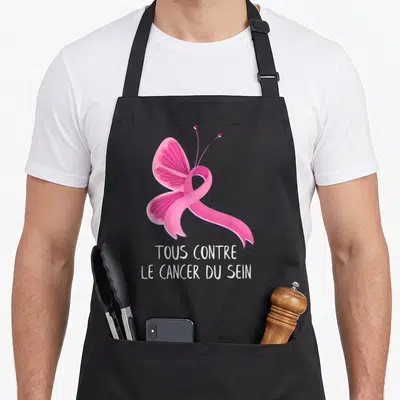 Tablier de cuisine noir avec un ruban rose stylisé en papillon et le texte Tous contre le cancer du sein imprimé en blanc.
