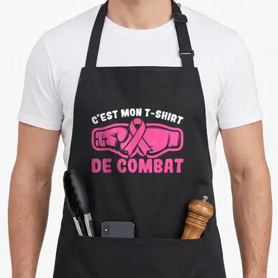 Tablier de cuisine noir avec inscription C'est mon « t-shirt » de combat et gants de boxe roses surmontés d'un ruban rose.
