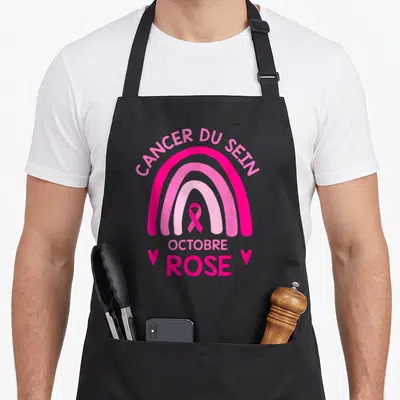 Tablier de cuisine noir avec un arc rose, un ruban et les mots Cancer du Sein Octobre Rose