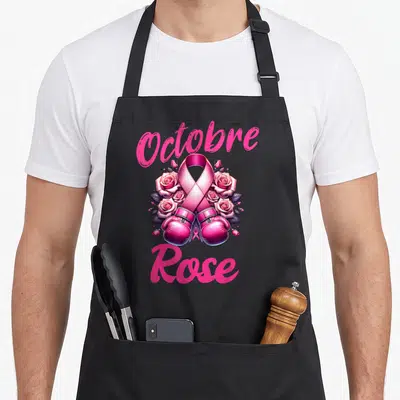 Tablier de cuisine noir avec un ruban rose, des roses et des gants de boxe roses imprimés au centre.