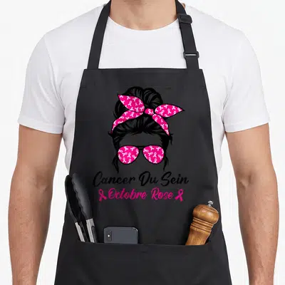 Tablier de cuisine noir avec illustration femme au bandana rose et lunettes de soleil ornés de rubans blanc et texte Cancer Du Sein Octobre Rose.