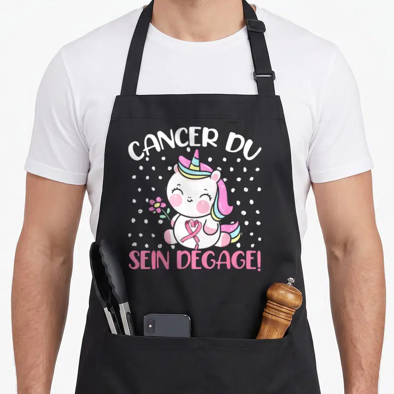 Tablier de cuisine noir avec licorne rose tenant une fleur et un ruban rose.