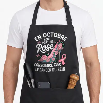 Tablier de cuisine noir avec escarpins roses, roses, ruban rose et texte sur la conscience du cancer du sein.