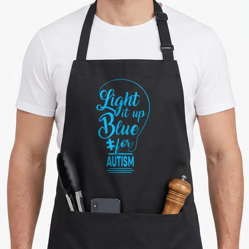 Tablier de cuisine noir avec motif ampoule bleue Light it up Blue for Autism