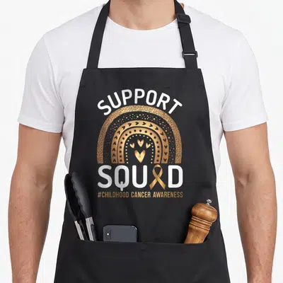 Tablier de cuisine noir avec illustration arc-en-ciel doré, cœurs et texte Support Squad ruban doré.