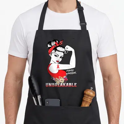 Tablier de cuisine noir avec illustration Rosie la rivale Fibro Warrior incassable et ruban rouge de sensibilisation.