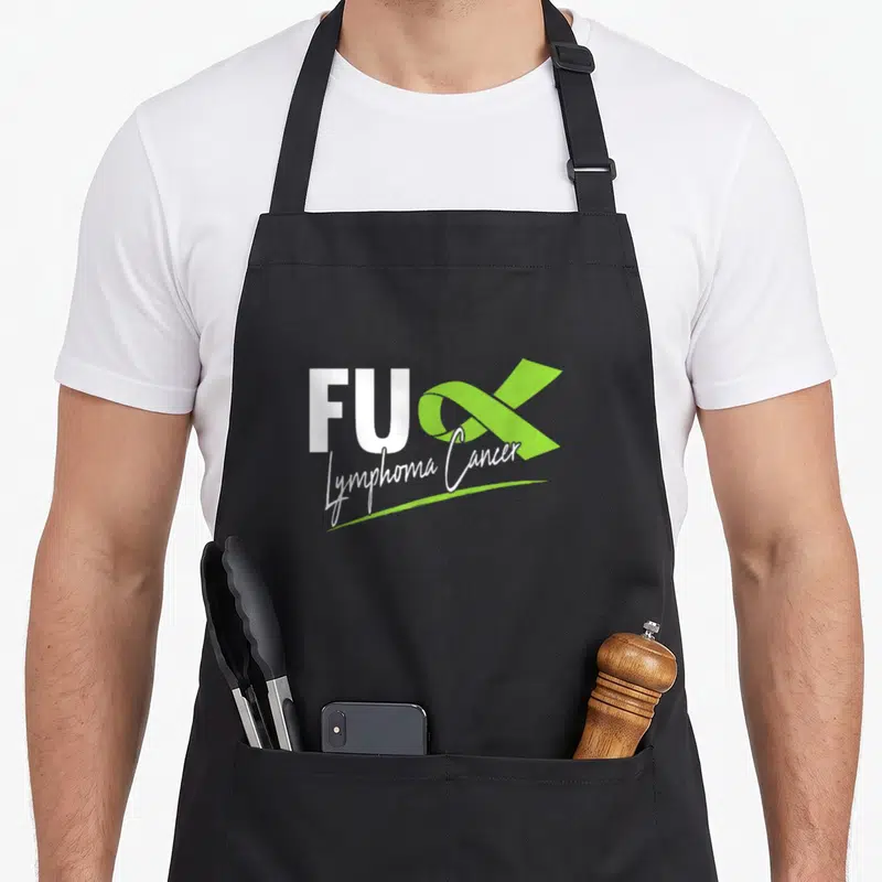 Tablier de cuisine noir avec l'inscription FUX Lymphoma Cancer et un ruban vert citron stylisé.