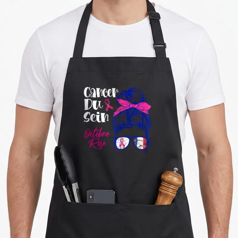 Tablier de cuisine noir avec illustration femme au chignon ruban rose et texte Cancer Du Sein Octobre Rose.