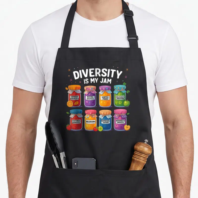 Tablier de cuisine noir avec illustration de jars colorés portant des messages sur la diversité et l'inclusion.