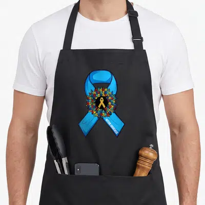 Tablier de cuisine noir avec un grand ruban bleu en forme de fleur de puzzle et un ruban doré central.