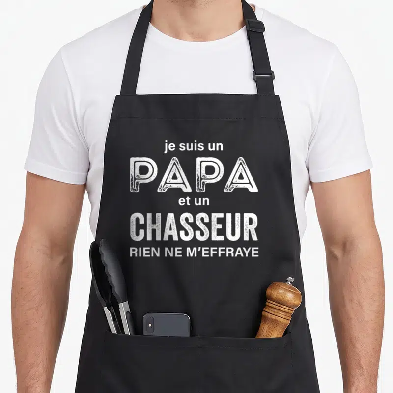Tablier de cuisine noir avec inscription blanche je suis un papa et un chasseur rien ne m'effraye en typographie usée.