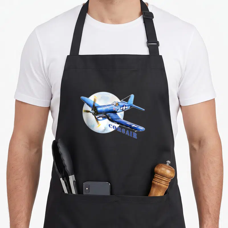 Tablier de cuisine noir avec illustration d'un avion Corsair bleu et inscription CORSAIR