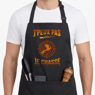 Tablier de cuisine noir avec inscription orange J'peux pas je chasse le faisan et motif visée.