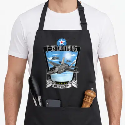 Tablier de cuisine noir avec illustration d'un chasseur F-35 Lightning et l'inscription Air Superiority.