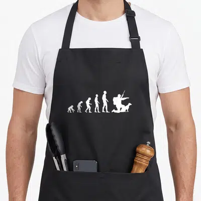 Tablier de cuisine noir avec illustration blanche représentant l'évolution humaine terminant par un chasseur agenouillé avec chien et fusil.