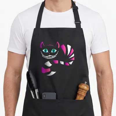 Tablier de cuisine noir avec un chat stylisé aux yeux verts, dents pointues et queue rose et blanche.