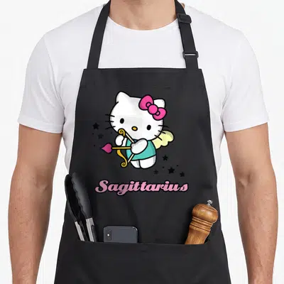 Tablier de cuisine noir avec Hello Kitty Sagittarius tenant un arc doré entouré d'étoiles noires et du texte Sagittarius en rose.