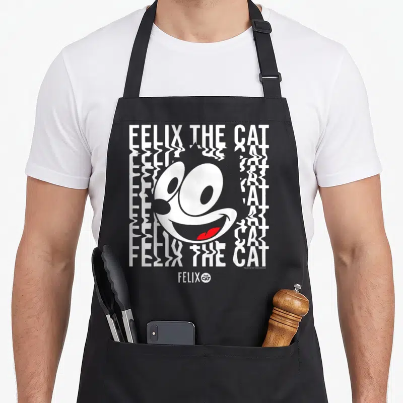 Tablier de cuisine noir avec illustration glitchée de Felix le Chat et texte blanc ondulé.