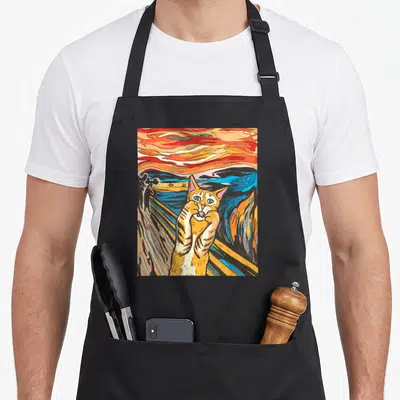 Tablier de cuisine noir avec une illustration colorée d'un chaton imitant Le Cri sur fond de ciel tourmenté.