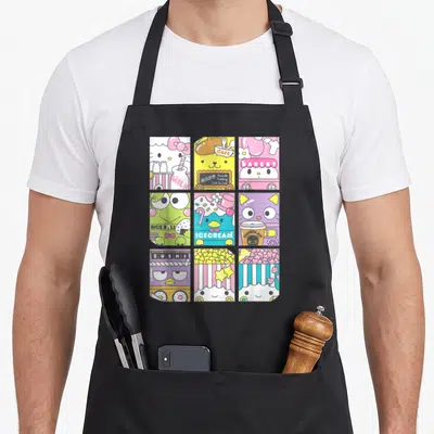 Tablier de cuisine noir avec neuf illustrations colorées de personnages Sanrio dans des univers de boulangerie et de dessert.