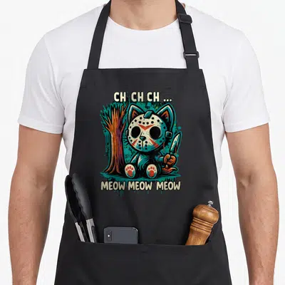 Tablier de cuisine noir avec un chat en masque de tueur tenant un couteau et le texte Ch Ch Ch Meow Meow Meow.