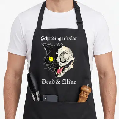 Tablier de cuisine noir avec illustration d'un visage de chat moitié vivant moitié crâne et texte gothique Schrödinger's Cat Dead & Alive